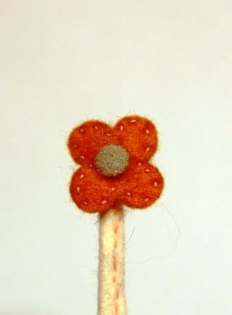 Orange grey small felt flower small.jpg