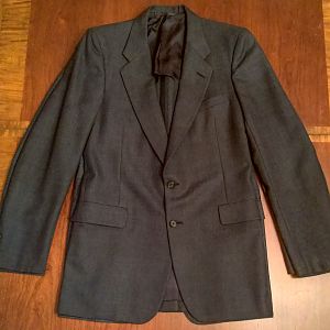 The Boardroom jacket is shown laying on top of the Vanguard sport coat. The outer silhouettes and arm holes are similar, and both designs feature front darts. The Boardroom was altered to suppress the waist.