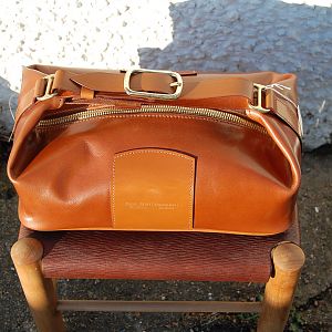 A toilet / wash bag in fine calf, with bridle leather trim and strap. Lined with a washable fabric PU material. I was sub-contracted to repair luggage and cases for Harrods and Gucci when I worked in London, and this was my 'take' on a 1930's? Gucci bag.