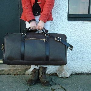 A bridle pigskin Hold all ( duffle in the US ) with Bridle strapping and handles. Machine stitched main body, all chapes and the detachable shoulder strap are hand stitched. Lined with a cotton duck material