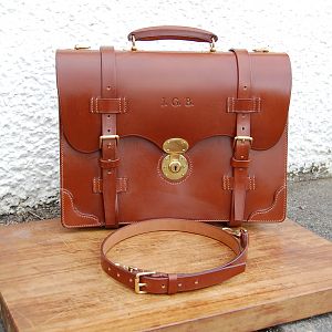 This is a 3 pocket Bridle Leather brief case, with a scallopped front and extra corner protection pieces. Entirely hand stitched, apart from the partition board top binding. Made using J. E. Sedgewicks conker bridle butt. Photographs do not do the leather colour justice, I love this leather.