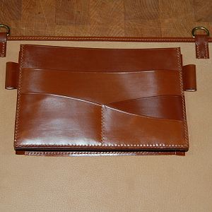 A bespoke addition to the Scalloped fronted conker brief case. The client wanted an alsortment of pockets on the rear partition board, along with a couple of pen loops, and a D-ring to attach his keys to.