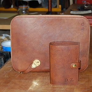 A shot of an Under-arm Folio case, entirely hand stitched, in Russian Reindeer hide with a pigskin lining, along with a filofax Organiser, the organiser is machine stitched, both embossed with initials.