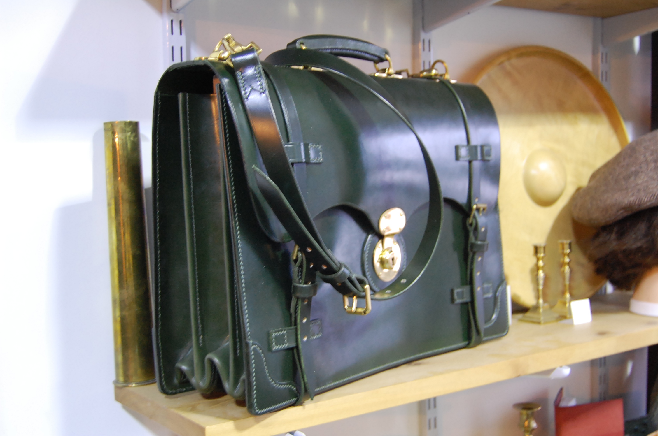 An XL sized, Scallop fronted, 3 pocket/2 partition brief case, in a dark Green bridle leather I had made for me. Entirely hand stitched, except for the partition board top binding.