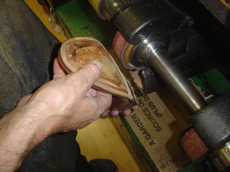 Edges of the sole.

What isn't shown is how the rest of the bottom of the shoe is also cleaned using a finer-grit abrasive. The cleaner the surface, the better the glue will stick, so it's important that a shoemaker pays attention to this.