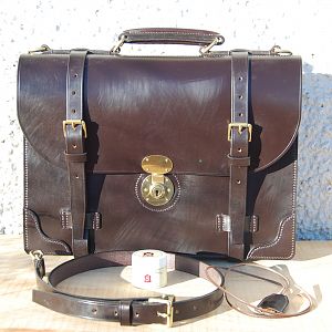A hand stitched 2 pocket dark havana briefcase.