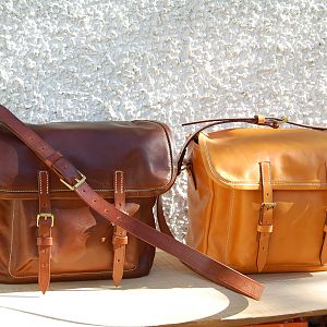 A pair of Sedgwicks bridle panel hide satchels, with bridle butt strapping and shoulder straps, machine stitched. London colour and conker