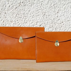 A pair of entirely hand stitched bridle leather under arm folios, std. and small, in Sedgwick's light havana.