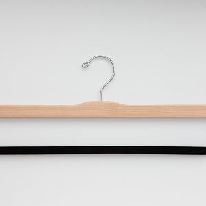 Our Felted Trouser Bar hanger (pictured in the natural finish) doesn't leave trousers creased because of the flocked bar. Also, we have optimized the drop of our bar to make it as easy as possible to thread the trousers.