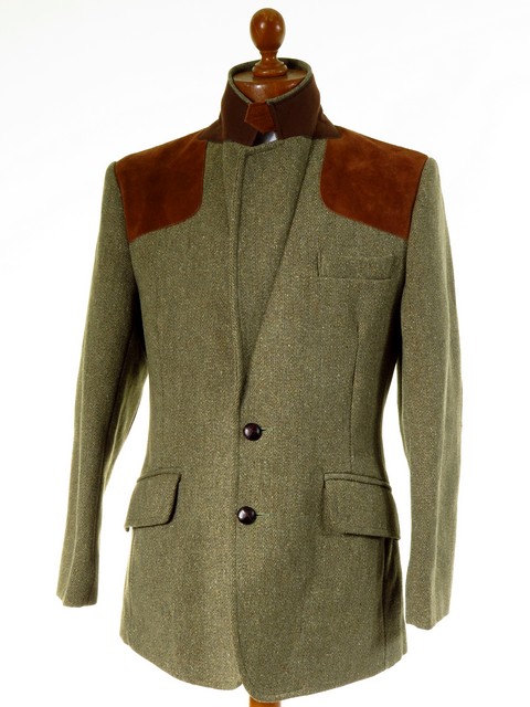 Tweed shooting jacket with suede gun pad to shoulders, suede elbow patches, action back and half belted.